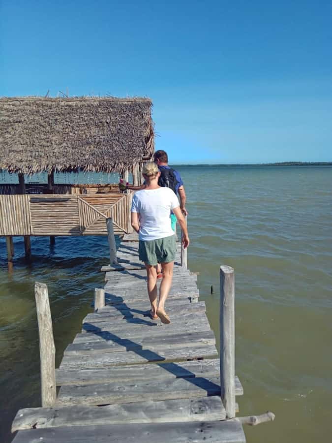 Watamu: Sunset Mangrove Canoe Tour with Coconut Drink - Pushing a dugout canoe through the mangroves